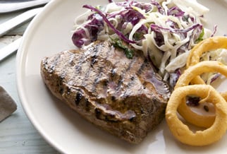Flat iron steak with onion rings and russian slaw