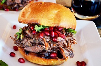 Pulled Lamb Sandwich with Pomegranate Port Wine Sauce on a Toasted Brioche Bun