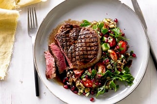 Grilled Aussie beef ribeye steaks with smoky eggplant and pomegranate salad