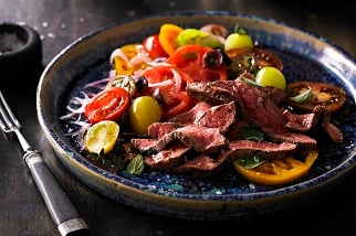 Grilled Aussie flat iron steak with tomato, olive and oregano salad